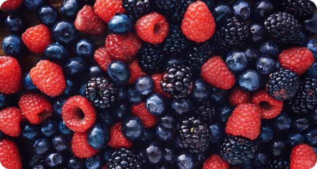 A mix of fresh raspberries, blackberries, and blueberries.