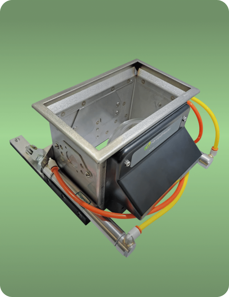 A metal rectangular industrial component with orange and yellow cables on a green background.