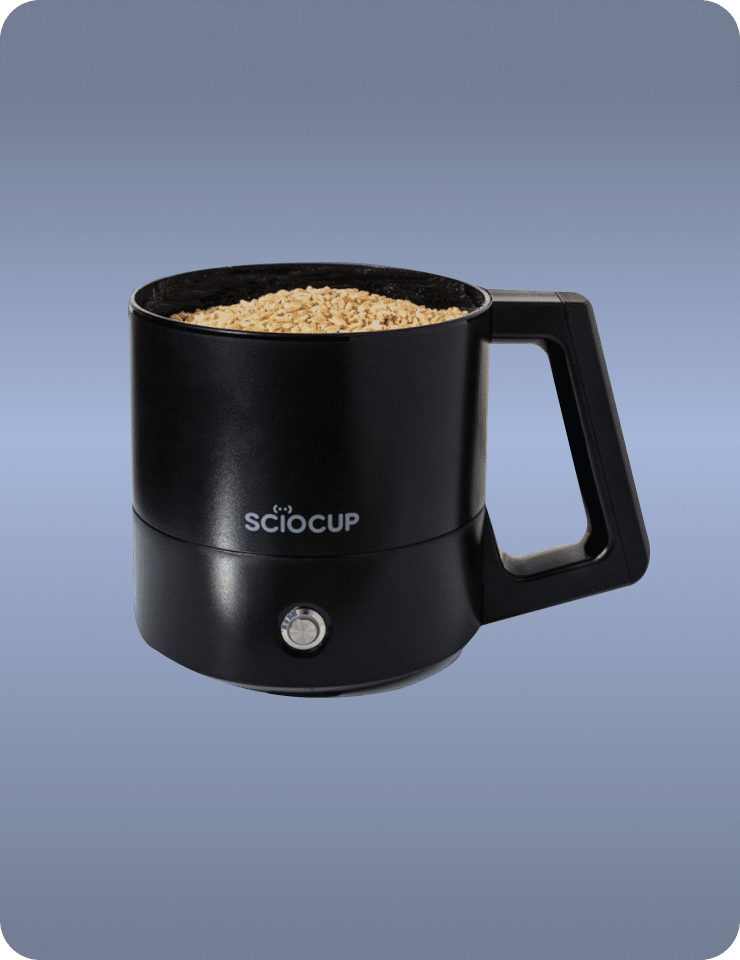 A black SciOcup mug filled with oats, featuring a handle and a single button on the front.