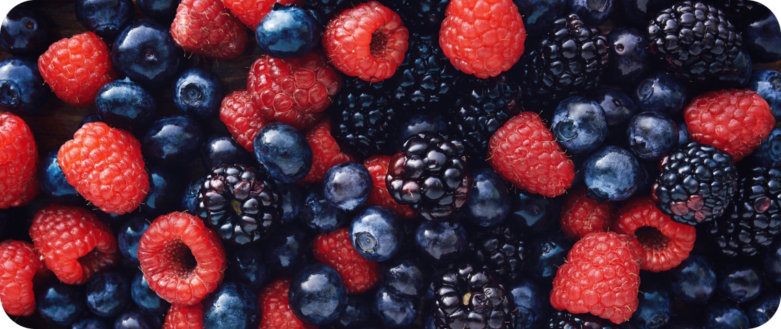 A close-up of mixed berries including raspberries, blueberries, and blackberries.