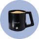 Black electric coffee mug with a digital display on a light gray background.
